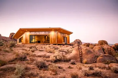 a house on the side of a hill with rocks at Amazing Lone Pine Cabin for Glamping in California in Lone Pine
