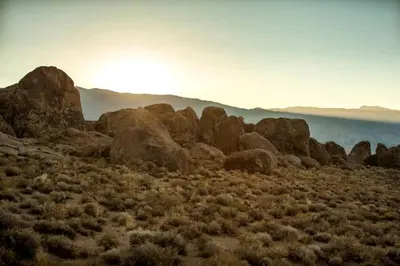 a group of rocks in the middle of a field at Amazing Lone Pine Cabin for Glamping in California in Lone Pine