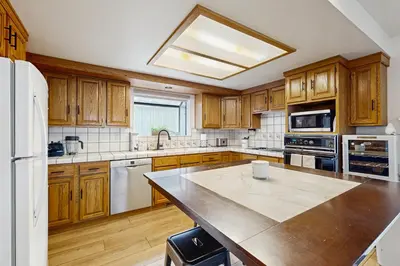 a kitchen with wooden cabinets and a large counter top at Modern Mountain Escape in South Lake Tahoe
