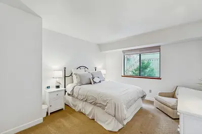 a white bedroom with a bed and a window at Modern Mountain Escape in South Lake Tahoe