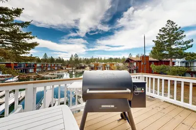a bbq grill on a deck overlooking a marina at Modern Mountain Escape in South Lake Tahoe