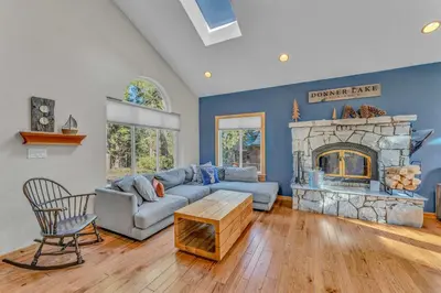 a living room with a couch and a fireplace at Spacious Pet-Friendly Truckee Retreat with Hot Tub in Truckee