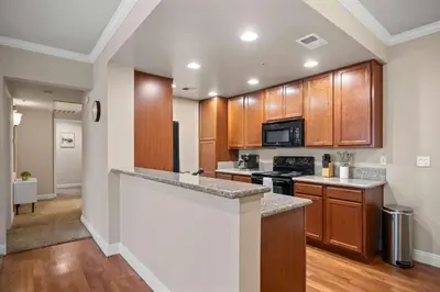 a kitchen with wooden cabinets and a counter top at Luxury 2BR 2BA Apartment with Pool Gym & Theater in Steamboat
