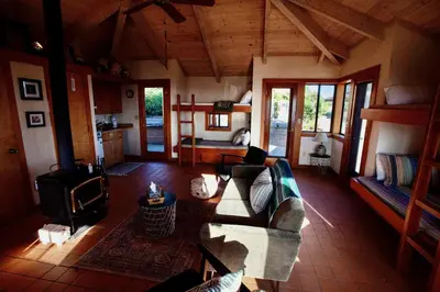 a living room with a couch and a stove at Priest Ranch with Guest House and Pool in Big Oak Flat