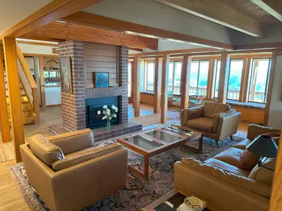 a living room with couches and a fireplace at Priest Ranch with Guest House and Pool in Big Oak Flat
