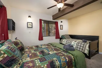 a bedroom with a bed and a window at Yosemite Aviary - Bird's Eye View Awesome Upper Unit in Yosemite West