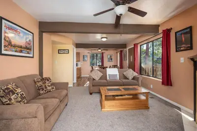 a living room with a couch and a table at Yosemite Aviary and Quail Within Yosemite - 2 Separate Family Units Welcoming Up To 14 Guests in Yosemite West