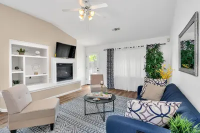 a living room with a blue couch and a tv at University Pastoral - Family Perfect Close to UCM in Merced