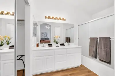 a white bathroom with a sink and a mirror at University Pastoral - Family Perfect Close to UCM in Merced