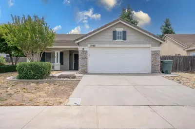 a house with a white garage in a yard at University Pastoral - Family Perfect Close to UCM in Merced