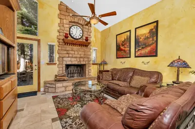 a living room with a couch and a fireplace at A Tuscan Adventure in California 3 BDR Sleeps 8 in Shaver Lake