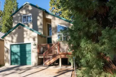 a house with a deck and a garage at A Tuscan Adventure in California 3 BDR Sleeps 8 in Shaver Lake