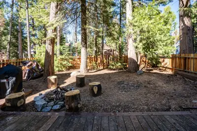 a campground with a fire pit and trees at A Tuscan Adventure in California 3 BDR Sleeps 8 in Shaver Lake