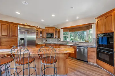 a kitchen with wooden cabinets and a wooden counter top at Gorgeous 5 BDR Traviloli Mountain Retreat for 10 in Shaver Lake