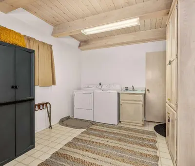 a kitchen with a washer and dryer in a room at Cavu Cabin - A Classic Mountainside Escape in Shaver Lake