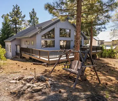 a house with a tree and a swing at Granite View Lodge - Minutes from Water in Shaver Lake