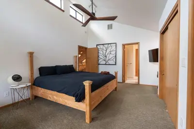 a bedroom with a bed and a ceiling fan at Happy Days Retreat with Private Pool in Bass Lake Annex