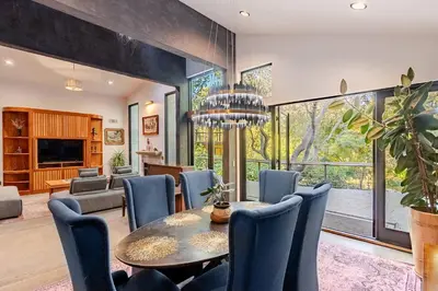 a dining room with a table and chairs at River Magic - Riverfront Family Fun & Lux Design in Three Rivers
