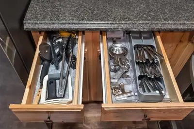 a wooden drawer with utensils under a counter at HNC0617 - Stagecoach Summit Retreat condo in Stateline