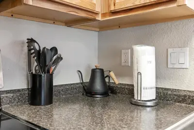 a kitchen counter with two black containers of utensils at HNC0617 - Stagecoach Summit Retreat condo in Stateline