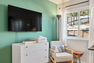a living room with a tv on a green wall at HNC0617 - Stagecoach Summit Retreat condo in Stateline