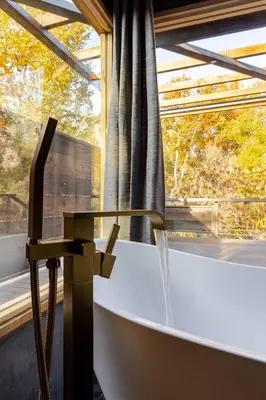 a bath tub in a room with a window at River Soul – Riverfront Luxury & Stunning Views in Three Rivers