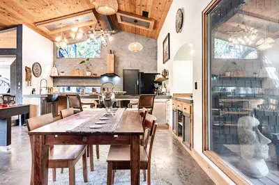 a large kitchen with a wooden table and chairs at River Soul – Riverfront Luxury & Stunning Views in Three Rivers