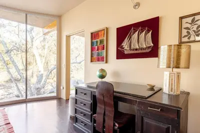 a home office with a desk and a lamp at Sequoia Arquitectural Wonder with Hot Tub & Views in Three Rivers