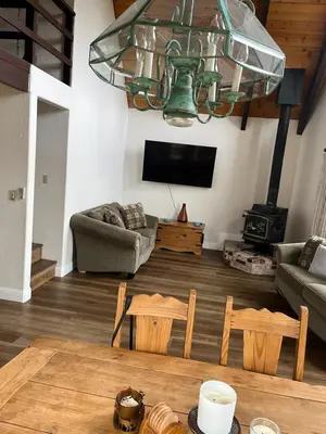 a living room with a couch and a table and chairs at Serenity View, Peaceful & Cheerful 3BD Cabin in Groveland