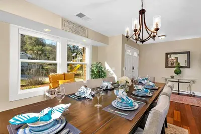 a dining room and living room with a table and chairs at Awesome Views Game Room Hot Tub and More in Oakhurst