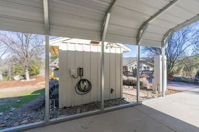 a building with a gate with the jlb logo on it at Awesome Views Game Room Hot Tub and More in Oakhurst