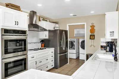 a kitchen with white cabinets and stainless steel appliances at Awesome Views Game Room Hot Tub and More in Oakhurst