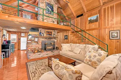 a living room with a couch and a fireplace at Rustic Knotty Pine - Old Cabin Vibes in Shaver Lake