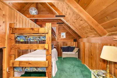 a bedroom with two bunk beds in a cabin at Rustic Knotty Pine - Old Cabin Vibes in Shaver Lake