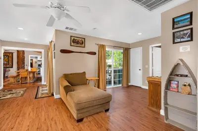 a living room with a couch and a ceiling fan at Immersed in Nature Manzanita Cabin with Hot Tub in Oakhurst