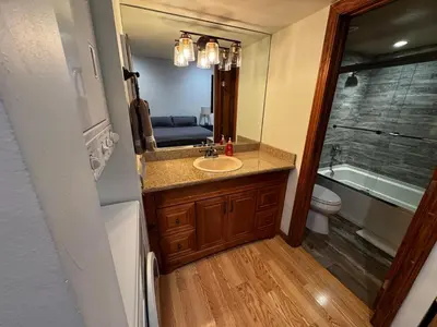 a bathroom with a sink and a toilet and a mirror at Spacious Condo walking distance to Hyatt and Beaches in Incline Village