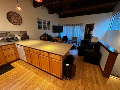 a kitchen with a counter and a living room at Spacious Condo walking distance to Hyatt and Beaches in Incline Village