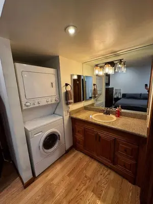 a bathroom with a washing machine and a sink at Spacious Condo walking distance to Hyatt and Beaches in Incline Village