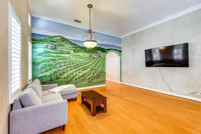 a living room with a painting on the wall at 5 Mi to Dtwn Modesto Family Home with Patio! in Modesto