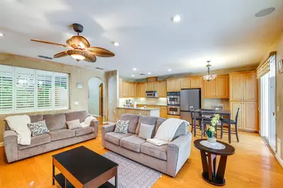 a living room with two couches and a kitchen at 5 Mi to Dtwn Modesto Family Home with Patio! in Modesto