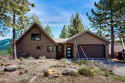 a brown house with a garage and some trees at Paradise on Pinnacle in Truckee