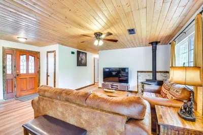 a living room with a leather couch and a tv at Sierra Serenity Scenic Mtn Escape with Game Room in Oakhurst