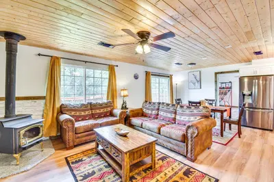 a living room with leather furniture and a wood ceiling at Sierra Serenity Scenic Mtn Escape with Game Room in Oakhurst