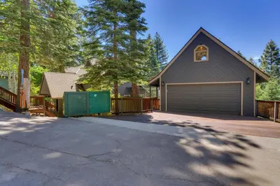 a house with a garage and a driveway at Hyphen 4-bedrooms rental, private beach, filtered view in Tahoe City