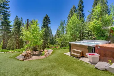 a hot tub in the middle of a yard at Hyphen 4-bedrooms rental, private beach, filtered view in Tahoe City