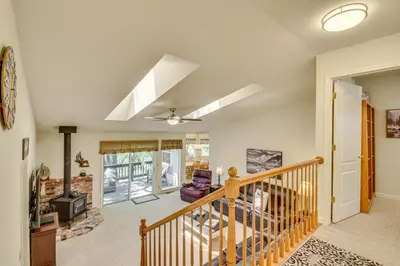 a room with a staircase and a living room at Yosemite Home Base Community Perks and Lake Access! in Groveland