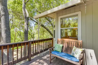a porch with a bench and a window at Yosemite Home Base Community Perks and Lake Access! in Groveland