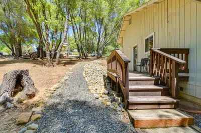 a porch of a house with wooden stairs next to it at Yosemite Home Base Community Perks and Lake Access! in Groveland