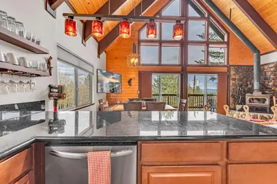 a kitchen with a large counter top and some windows at Spacious Truckee Retreat with Fireplace & Deck in Truckee