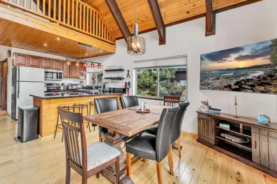 a kitchen and dining room with a wooden table and chairs at Spacious Truckee Retreat with Fireplace & Deck in Truckee